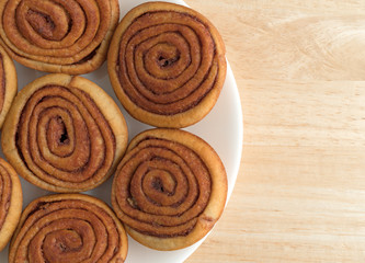 Plate of pecan sweet rolls on a wood table