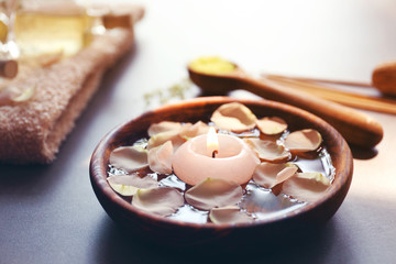 Petals in bowl with candle, closeup