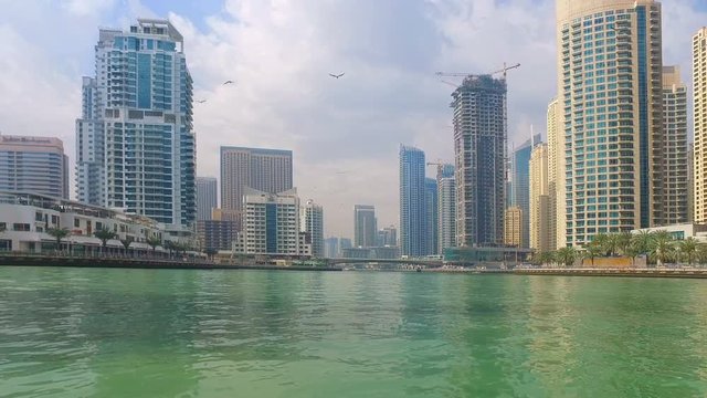 Sailing on Boat at Dubai Jumeira Marina video 4k. Skyscrapers modern buildings Travel tourism Real Estate business in United Arab Emirates