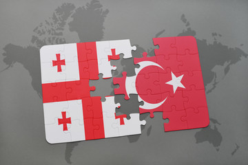 puzzle with the national flag of georgia and turkey on a world map background.