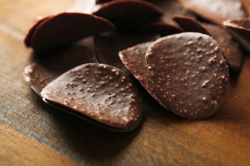Chocolate crisps on wooden background
