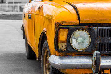 Vintage car yellow. Closeup. Broken.