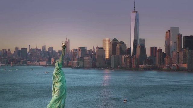 Aerial footage of New York City with Statue of Liberty, filmed at sunset.