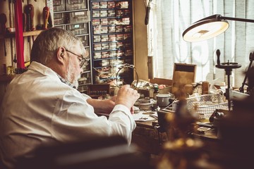 Horologist repairing a watch