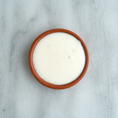 Fat-free blue cheese dressing in a small bowl on a gray marble counter top.