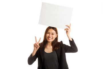 Young Asian business woman show victory sign with blank sign.