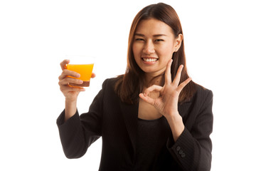 Young Asian woman show OK drink orange juice.