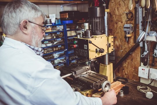 Horologist using a horological milling machine
