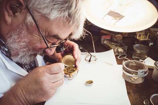 Horologist repairing a pocket watch