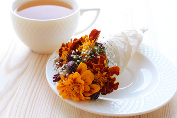 Bouquet of autumn flowers with a cup of tea