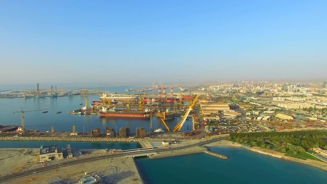 Aerial view Dubai ship yard in Persian gulf horizon panorama video 4k. Port Waterfront harbor Cargo Business in United Arab Emirates