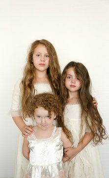 three little girls in vintage clothing
