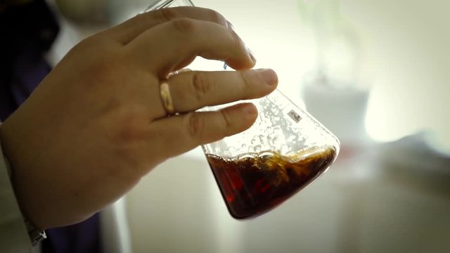 Consistency test of dark lager brown beverage, beer Schwarzbier
