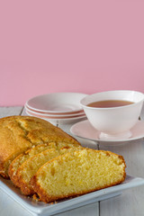 Madeira Cake with Tea on a Table Vertical with Copy Space on Pink
