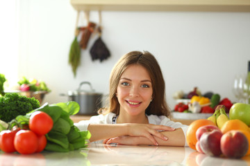 Young woman sitting near desk in the kitchen