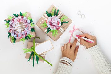 Gifts in colorful festive packaging with flowers and ribbons.
