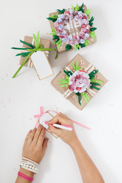 Gifts in colorful festive packaging with flowers and ribbons.