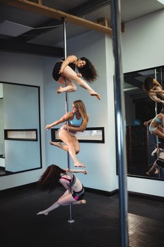 Pole dancers practicing pole dance