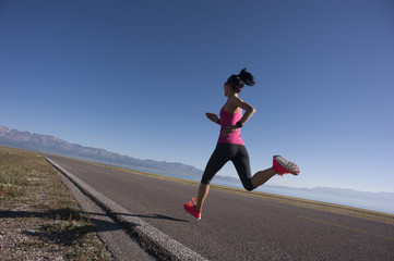 Fototapeta na wymiar young fitness woman runner running on sunrise seaside trail