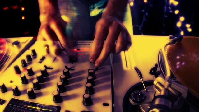 Hands of male DJ with turntables