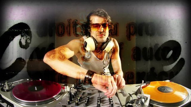 cool male dj behind the turntables