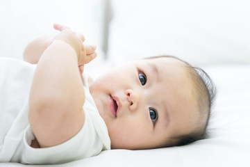 Portrait of a newborn Asian baby on the bed © alice_photo