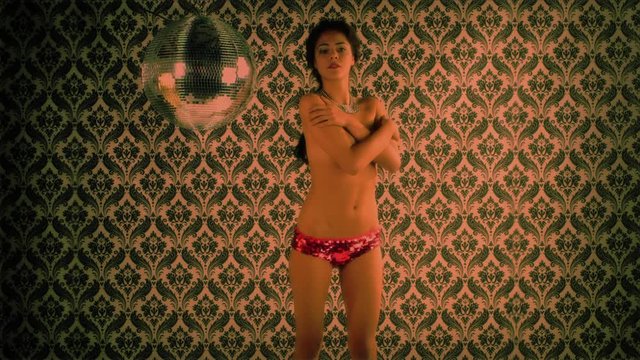topless woman dancing covering with her hands