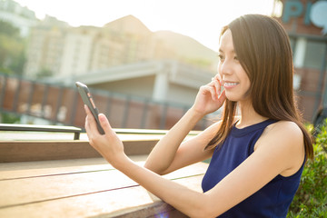 Fototapeta premium Woman using mobile phone at outdoor