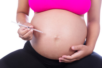 Pregnant woman with syringe on white background