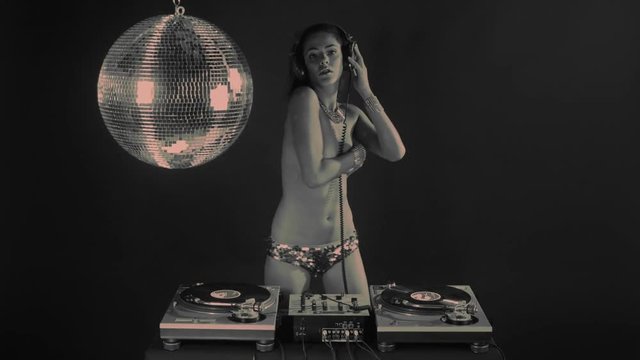 sexy female dj dancing and playing records