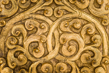 Swirling gold metalwork design.