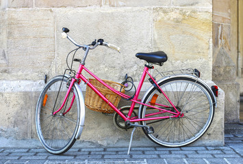 Fototapeta na wymiar Pink bike in city center of Krakow, Poland.