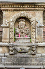 A small shrine set in a wall to Shiva in Nepal.