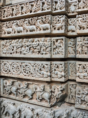 A wall covered in sculpted figures symbolizing different historical events at the 13th Century temple of Somanathapur, Karnataka, South India.