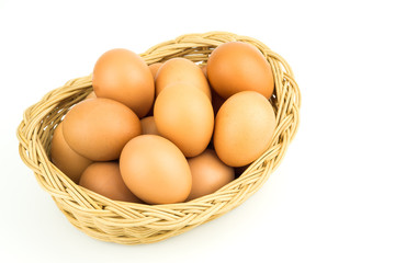 Eggs in basket isolated on white background
