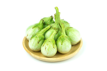 eggplant in wood plate on white background