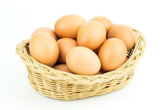 Eggs in basket isolated on white background