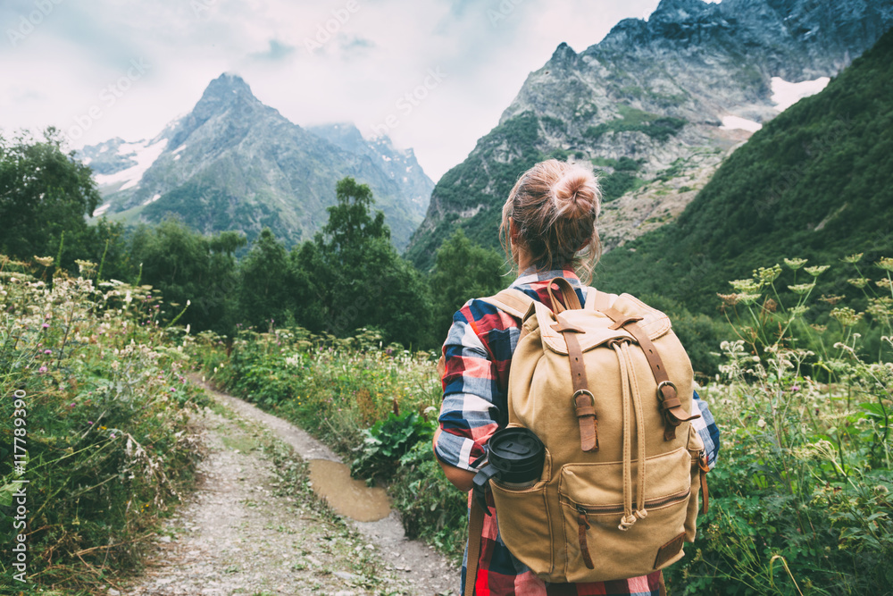 Wall mural hiker walking to mountains