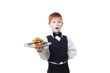 Little surprised boy waiter stands with tray serving hamburger