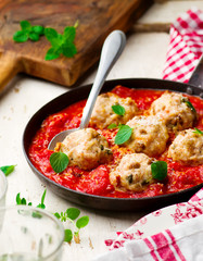 chicken meatballs with tomato sauce in a frying pan. style vintage