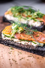 Charcoal Bread Smoked Salmon Sandwiches on wood board