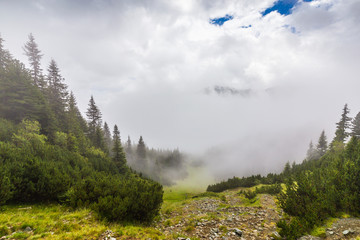 Mountain scenery in the Transylvanian Alps in summer, with mist clouds