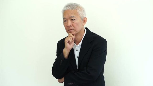 Asian senior businessman wearing suit thinking about his business