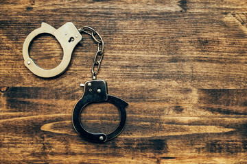 Police handcuffs on investigator detective's work desk