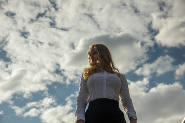 girl against the sky with clouds.