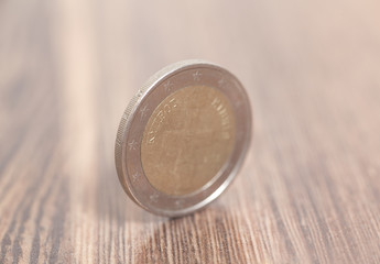 Two euro coin on a wooden surface