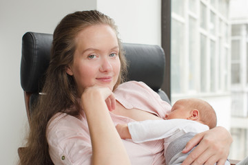 Mother nursing her newborn indoor