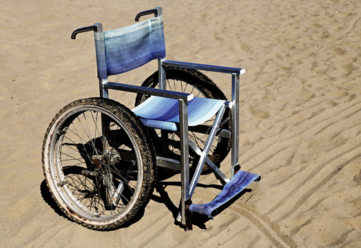 wheelchair on the sand of the beach