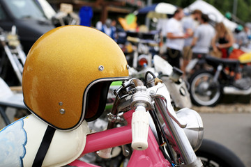 Naklejka premium Old vintage motorcycle with chrome accents and helmet