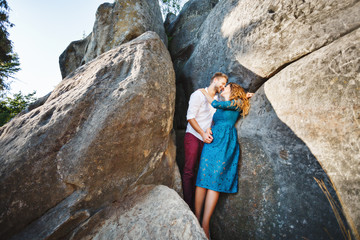 Cute couple embracing near rocks